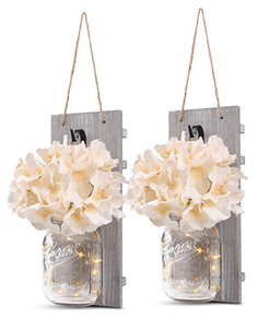 Two mason jar sconces with LED lights and white flowers to hang on the wall