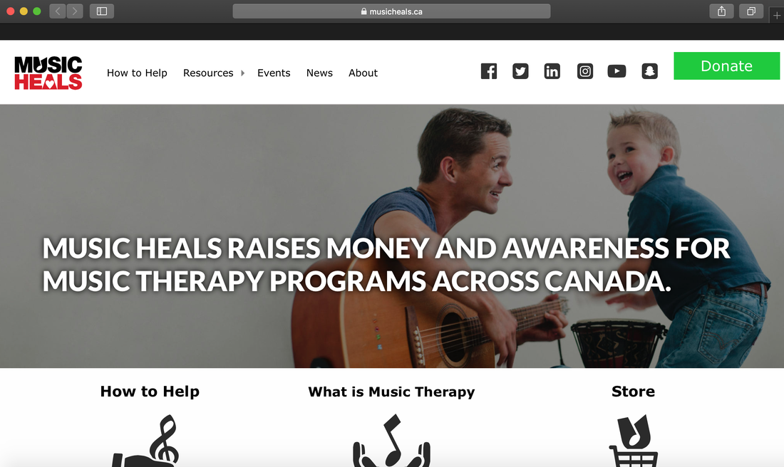 Homepage screenshot of Music Heals website showing a father playing guitar and his son playing a djembe